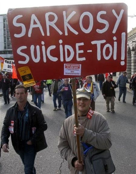  demonstrator carries a placard which reads "Sarkozy, commit suicide", referring to French President Nicolas Sarkozy, during a rally in central Paris, Thursday, Oct. 22, 2009. Several thousand workers and union leaders demonstrated in the French capital against what they fear are looming job cuts. Unemployment is continuing to rise in France, with figures released in September showing the number of people out of work had reached 9.1 percent in the second quarter of the year, an increase of 0.6 points from the first quarter.